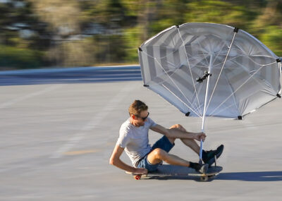 Skateboard land yacht, land sailor with beach umbrella sail in Western Australia