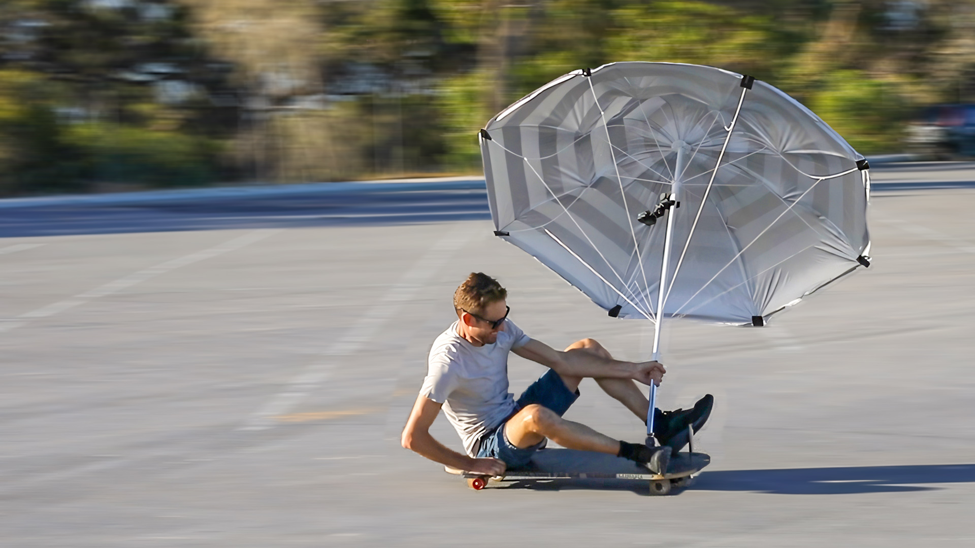 Skateboard land yacht, land sailor with beach umbrella sail in Western Australia